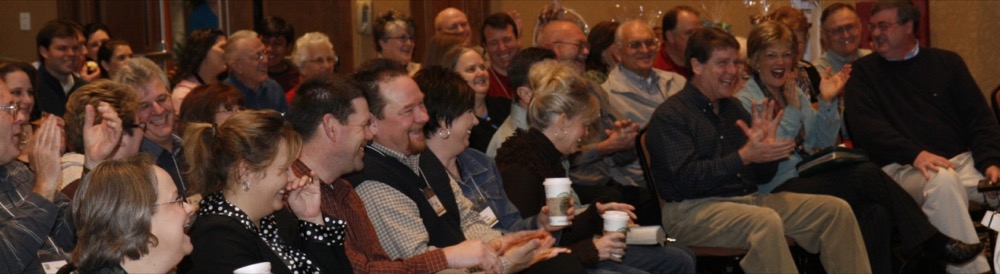 A corporate audience laughing during Matt's show